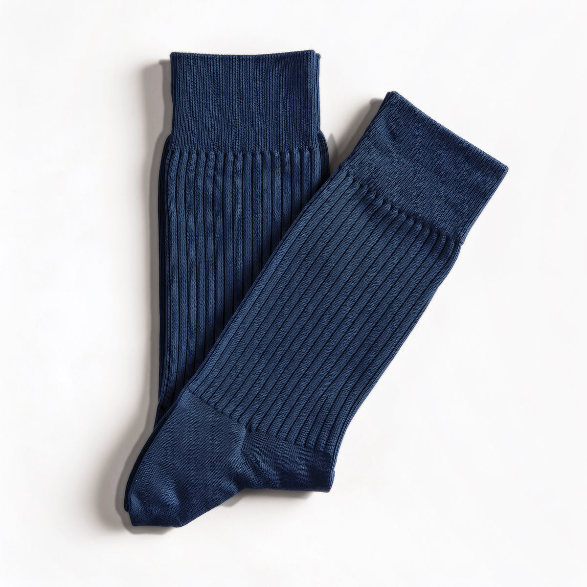 Navy ribbed crew socks, pair laid flat on white
