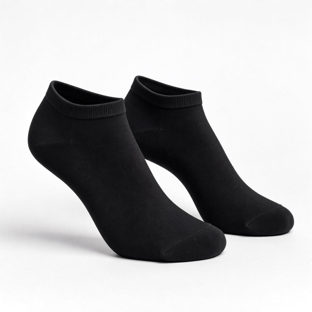 Black no-show trainer socks, pair standing on a white background