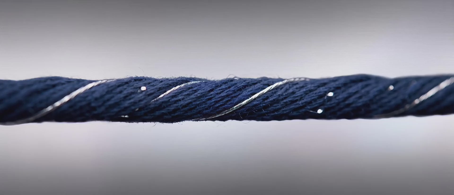 Navy cotton yarn twisted with a fine silver filament, on brushed silver