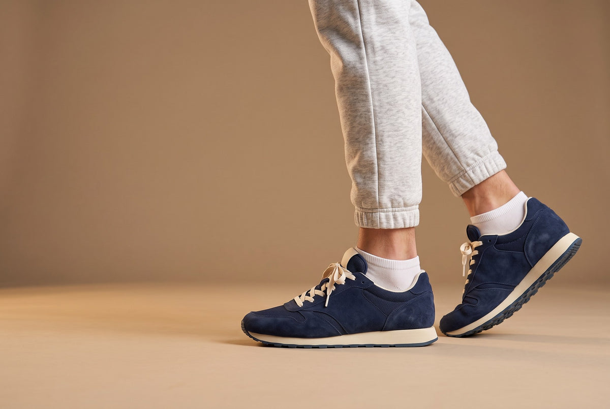 White Trainer Socks worn with navy suede sneakers, walking
